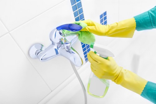 Oven cleaner inspecting interior components and ventilation